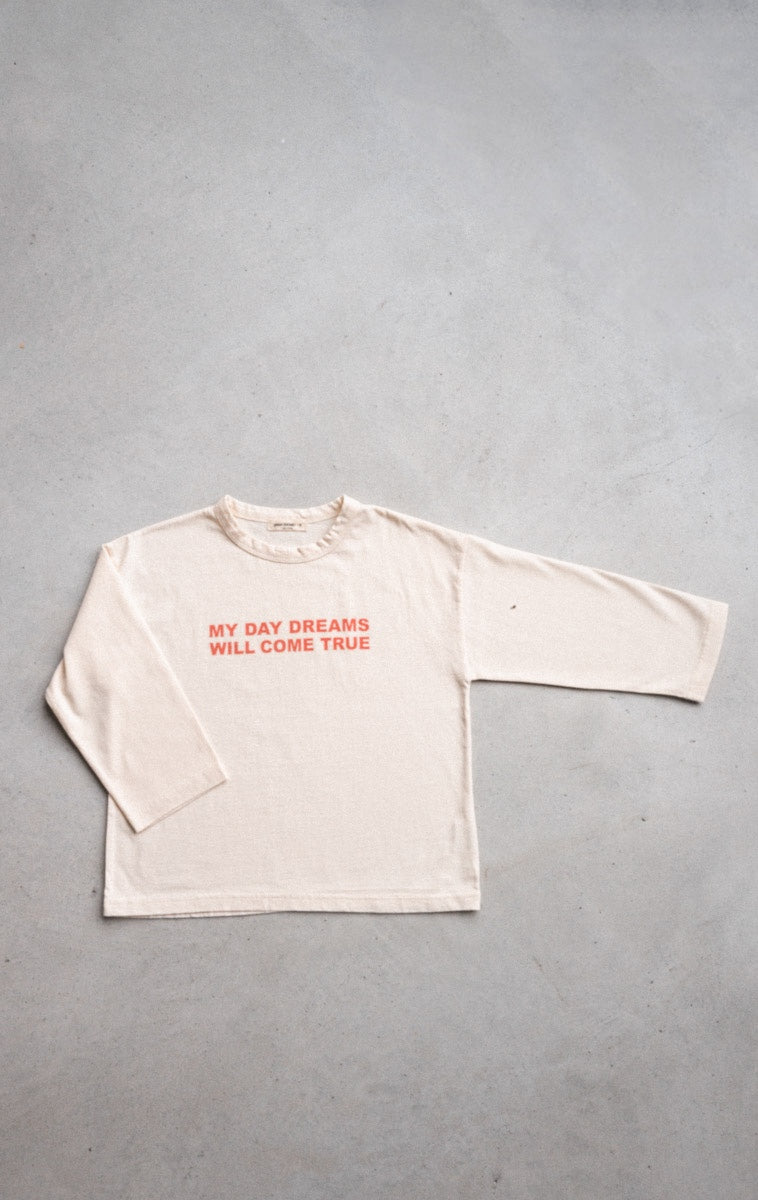 Ivory long-sleeve tee with "My Day Dreams Will Come True" print, designed for kids with loose fit for comfort and positive vibes.