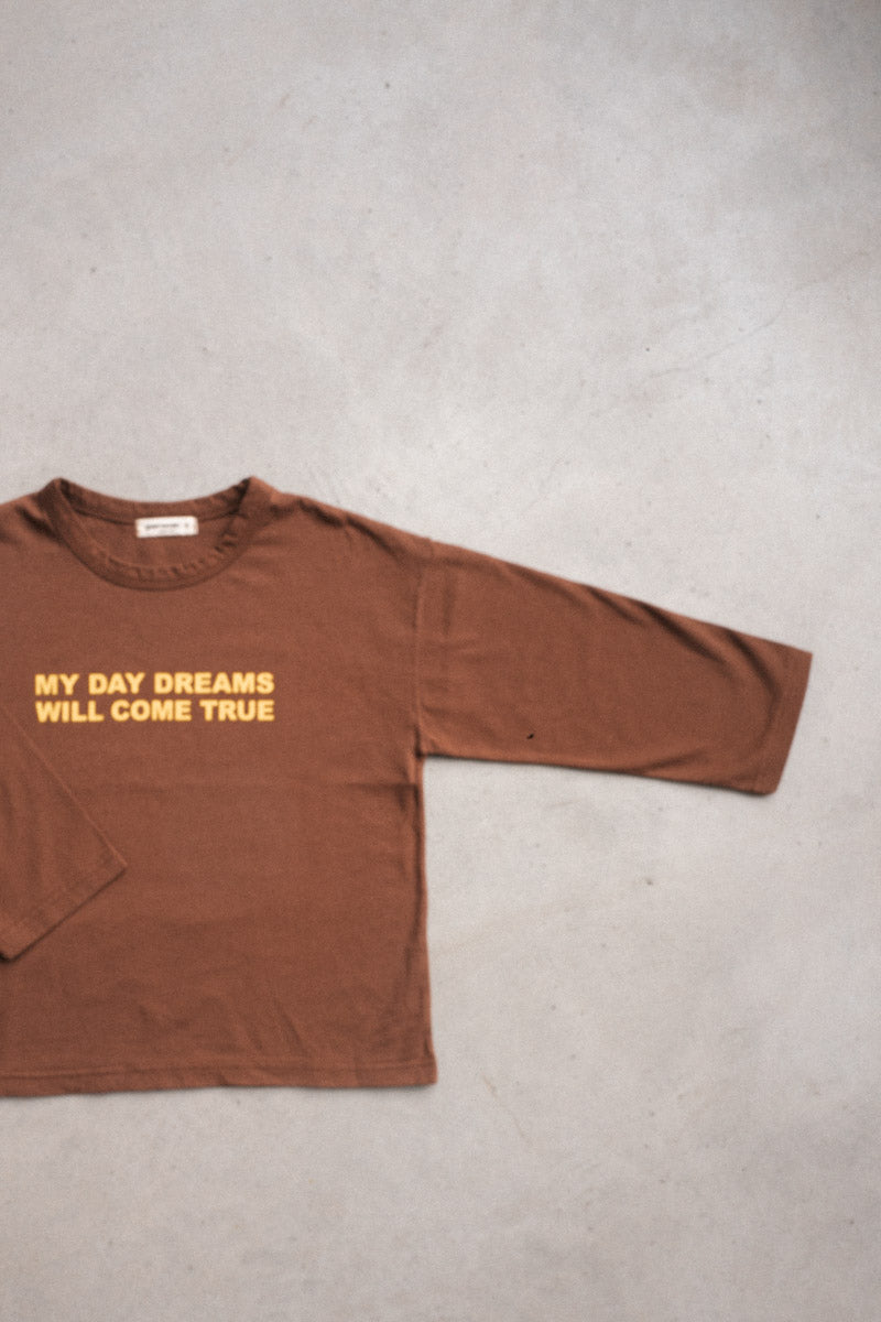 Chocolate long-sleeve tee for kids with positive "My Day Dreams Will Come True" print, part of the Every.Body selection.
