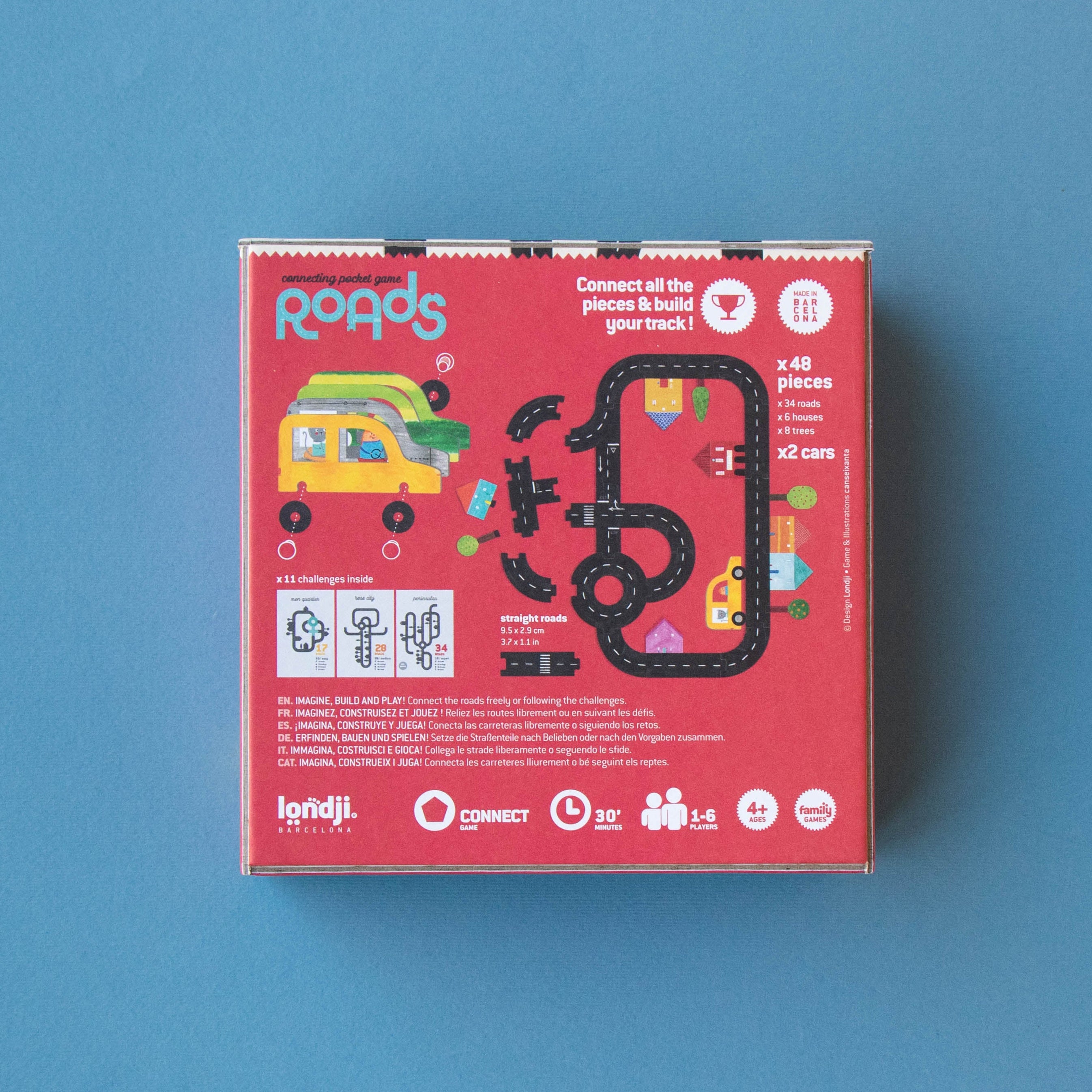 Red toy packaging box with colorful graphics on a blue background