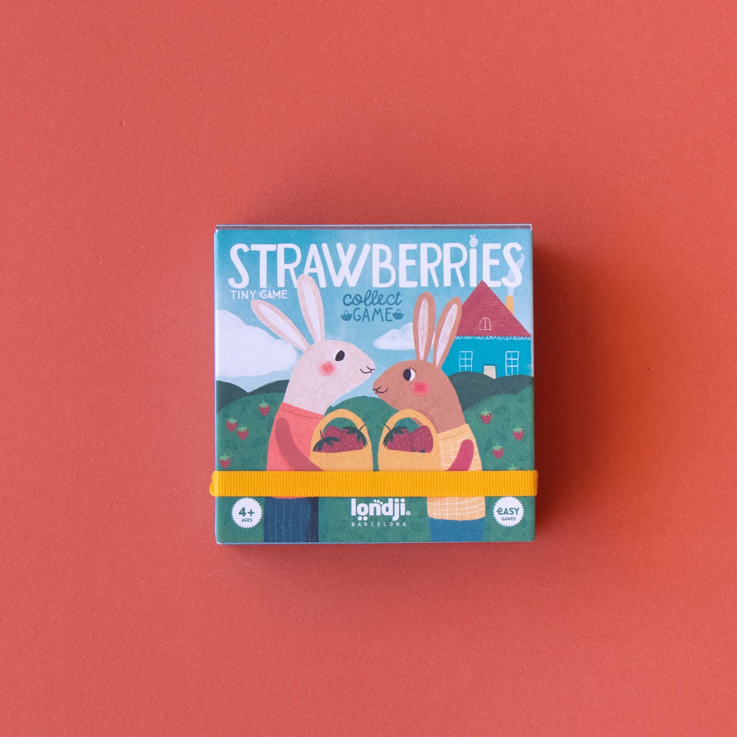 Box of strawberries with bunny design on a red background