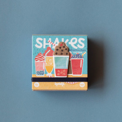 Box of shakes with colorful illustrations on a blue background